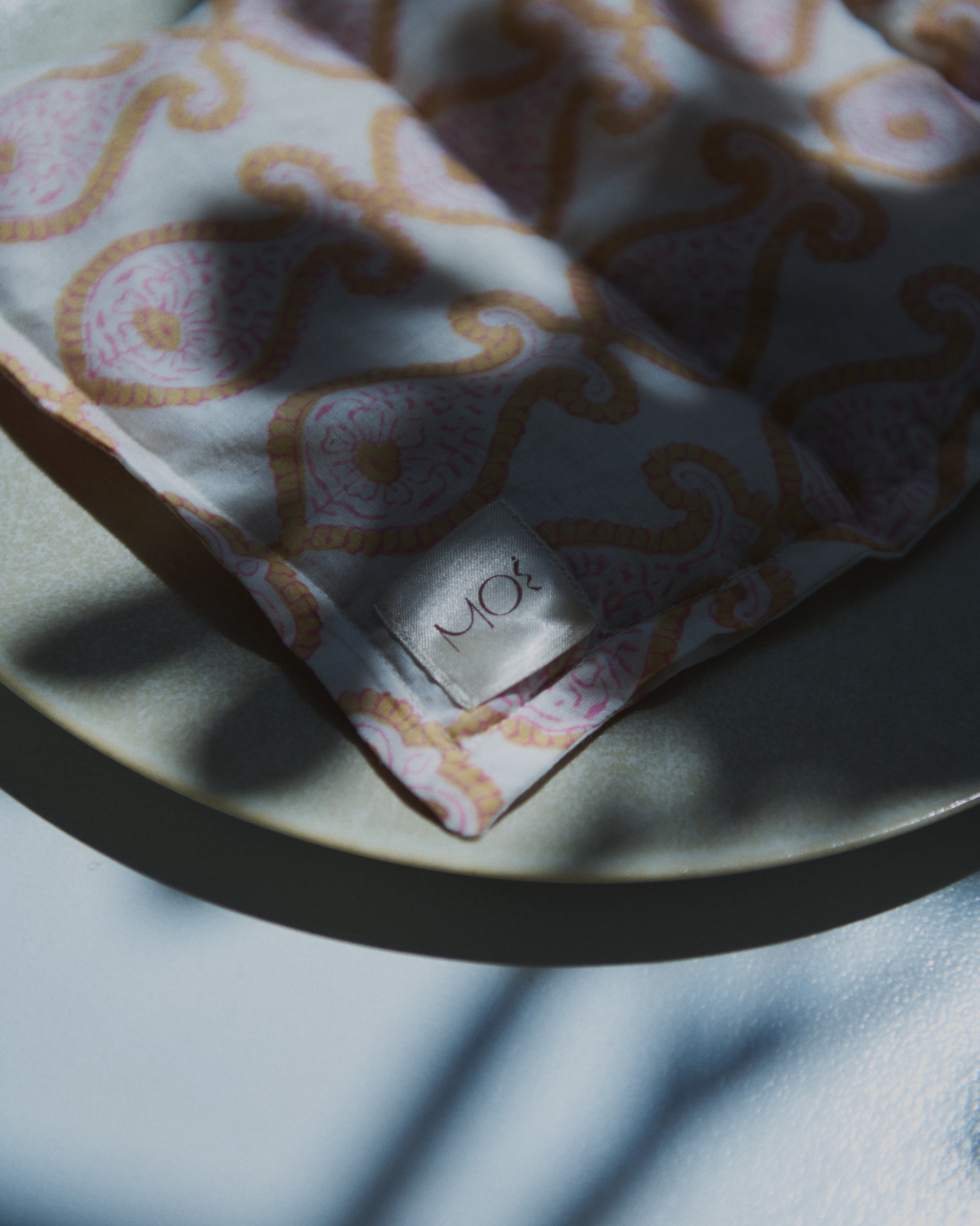 Patterned textile product detail with quiet shadow